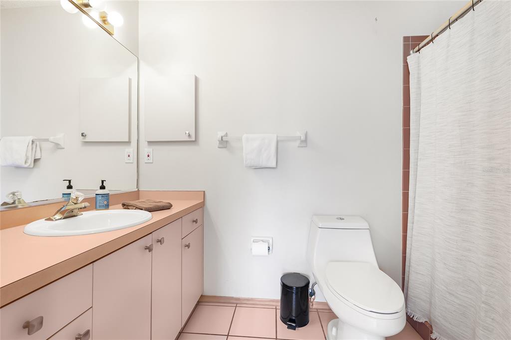 4537 South Lockwood Ridge Road Sarasota, FL 34231 - Photo 13 of 22 a bathroom with a toilet sink and mirror