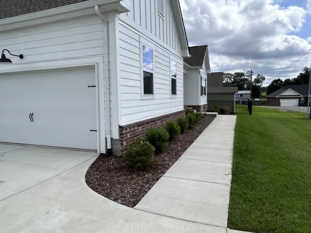 a front view of a house with a garden