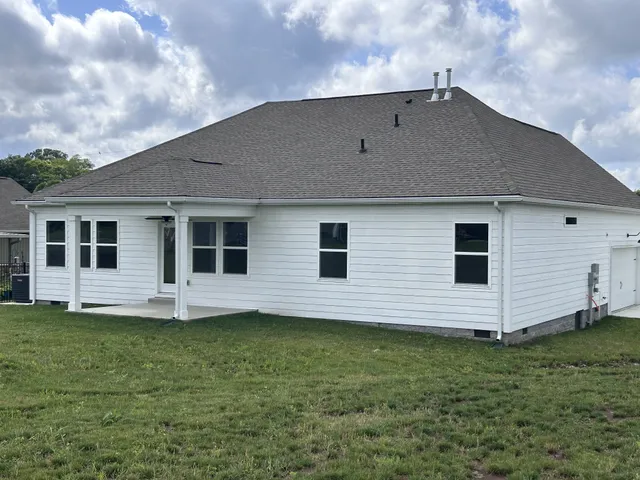 a view of a house with a backyard