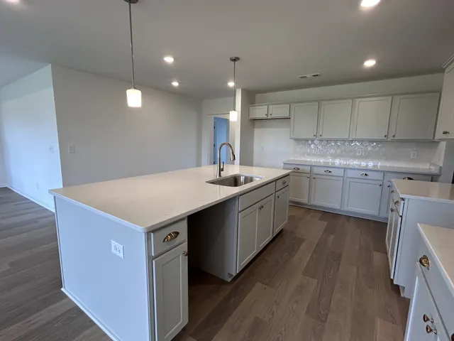 a kitchen with a sink window and cabinets