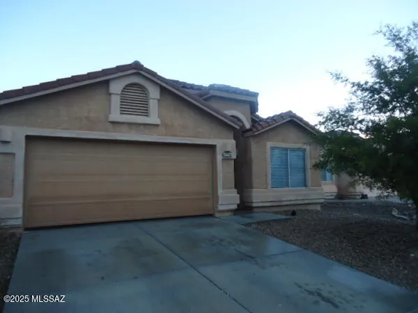a front view of a house with garage