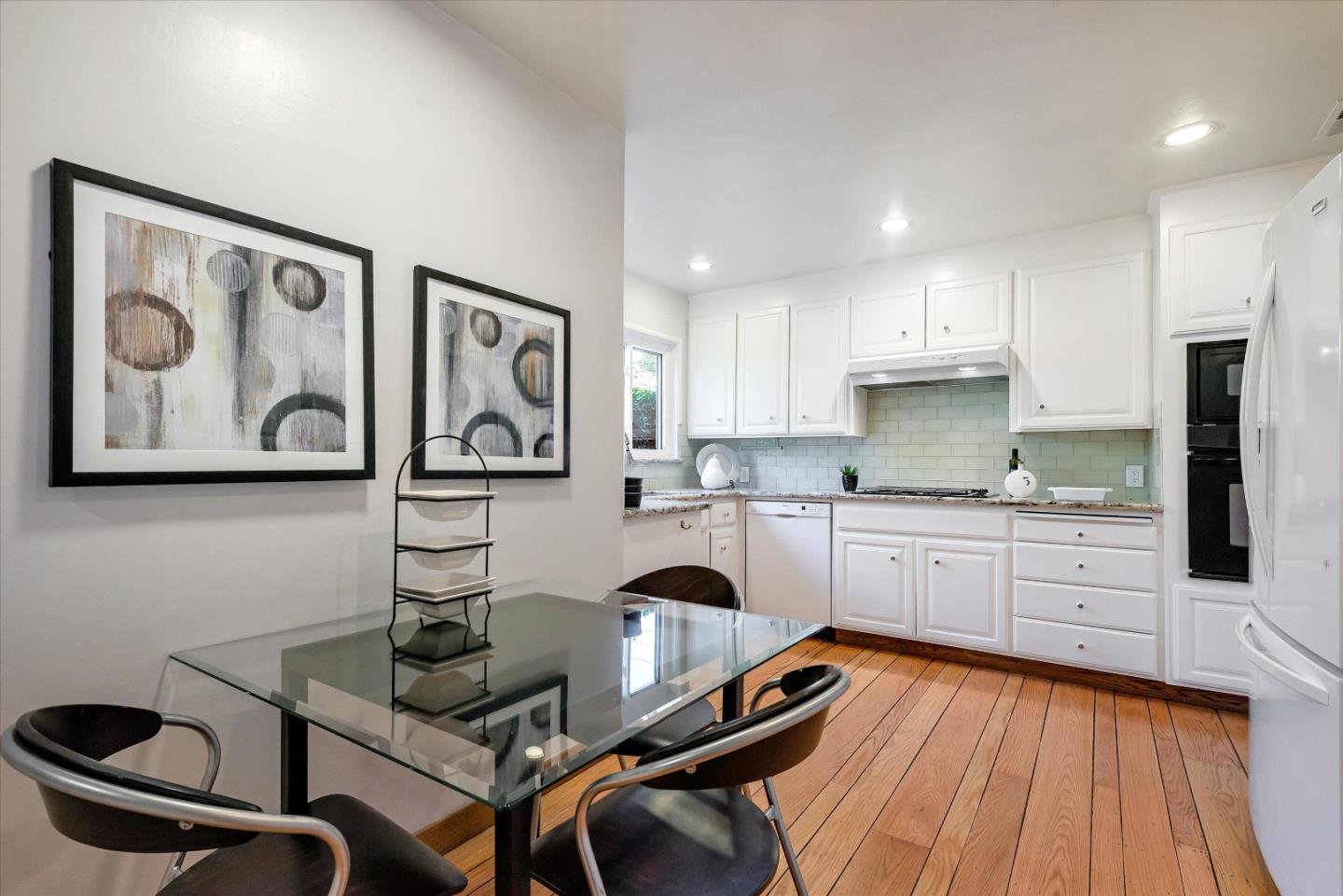 1649 Lee Drive Mountain View, CA 94040 - Photo 18 of 35 a open kitchen with stainless steel appliances granite countertop a stove a sink dishwasher and white cabinets with wooden floor