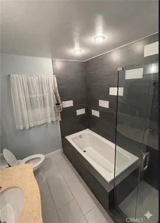 a bathroom with a bathtub and a shower