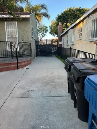 a view of a house with a wooden deck and a backyard