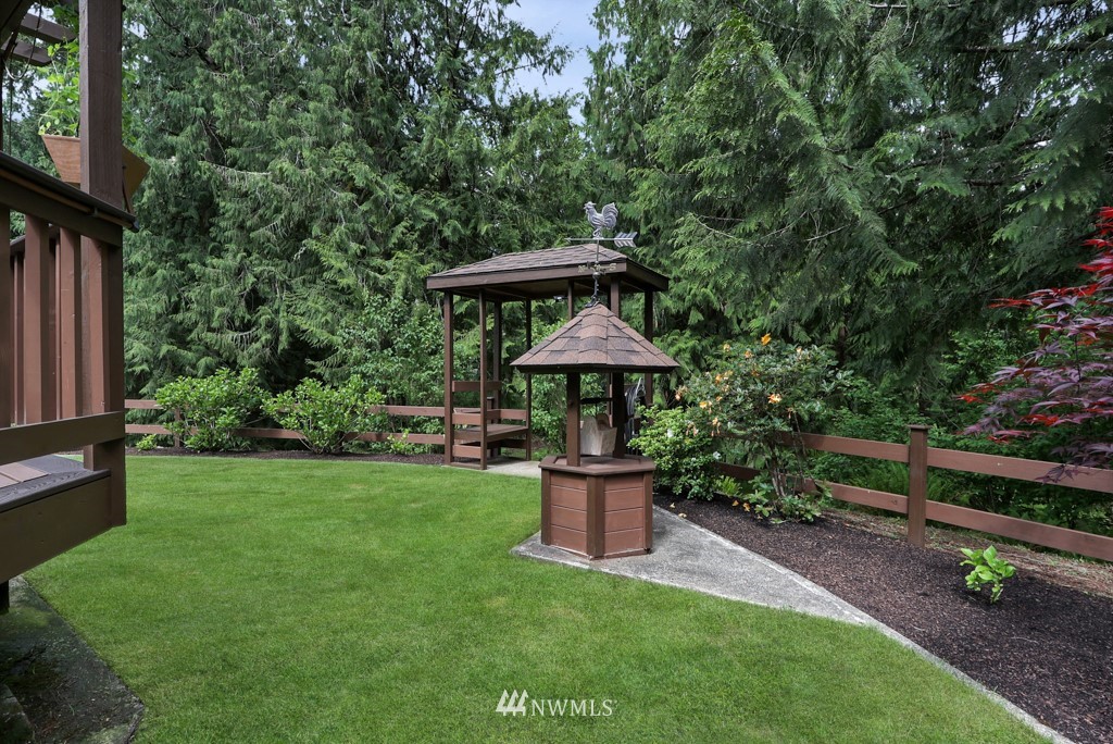 25308 Brooks Road East Orting, WA 98360 - Photo 12 of 40 a view of a backyard with potted plants and large trees