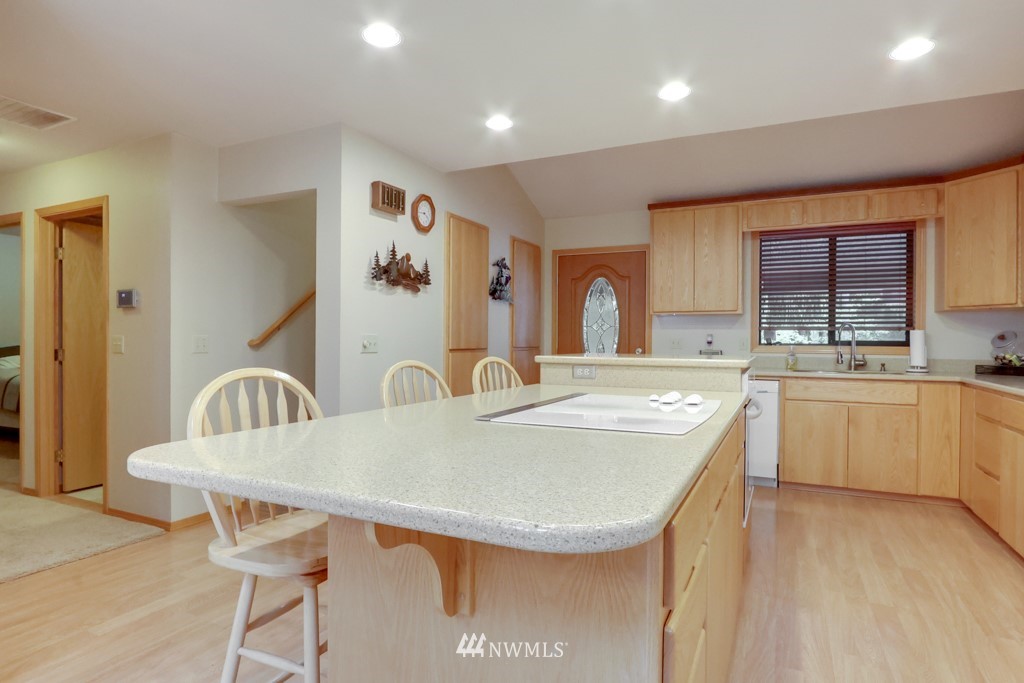 25308 Brooks Road East Orting, WA 98360 - Photo 19 of 40 a kitchen with kitchen island a appliances and cabinets