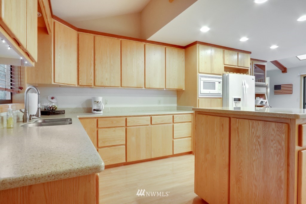 25308 Brooks Road East Orting, WA 98360 - Photo 20 of 40 a kitchen with stainless steel appliances granite countertop refrigerator sink and cabinets
