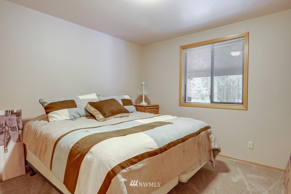 25308 Brooks Road East Orting, WA 98360 - Photo 24 of 40 a bed sitting in a bedroom next to a window