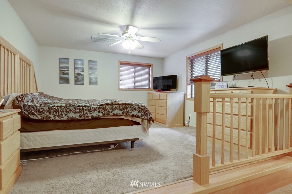 25308 Brooks Road East Orting, WA 98360 - Photo 27 of 40 a bedroom with a bed and a flat screen tv