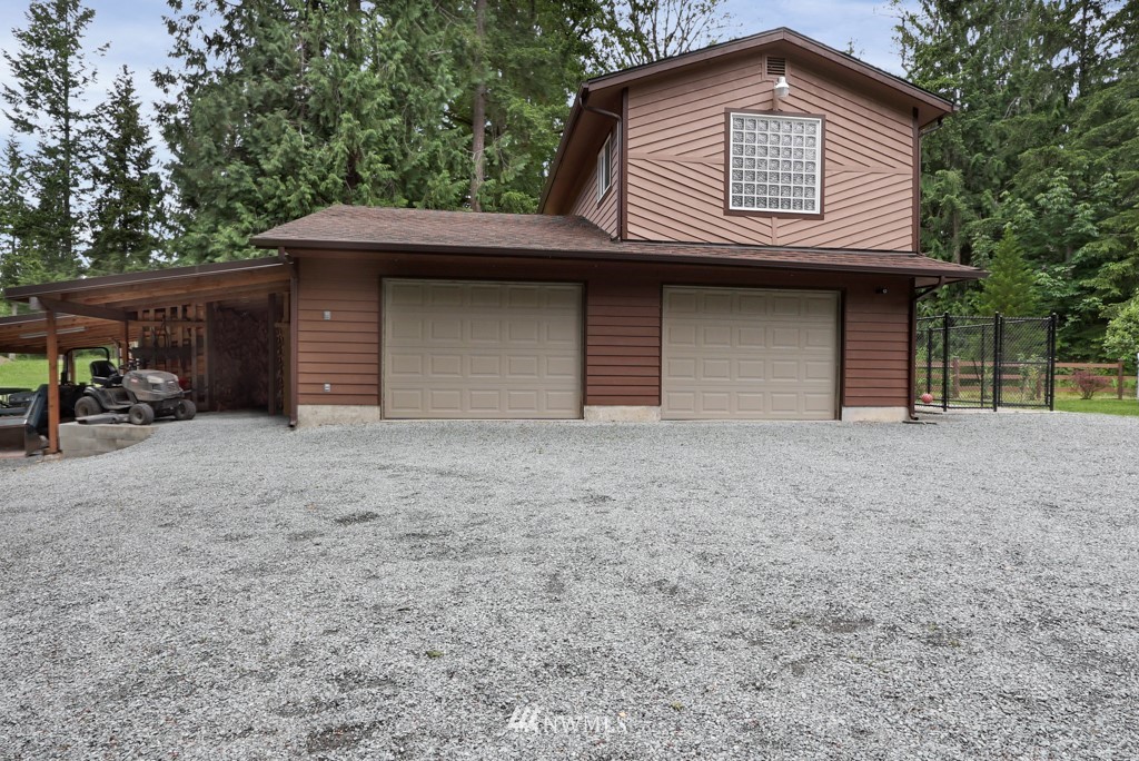 25308 Brooks Road East Orting, WA 98360 - Photo 5 of 40 a front view of a house with a yard and garage