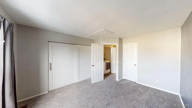 an empty room with windows and closet