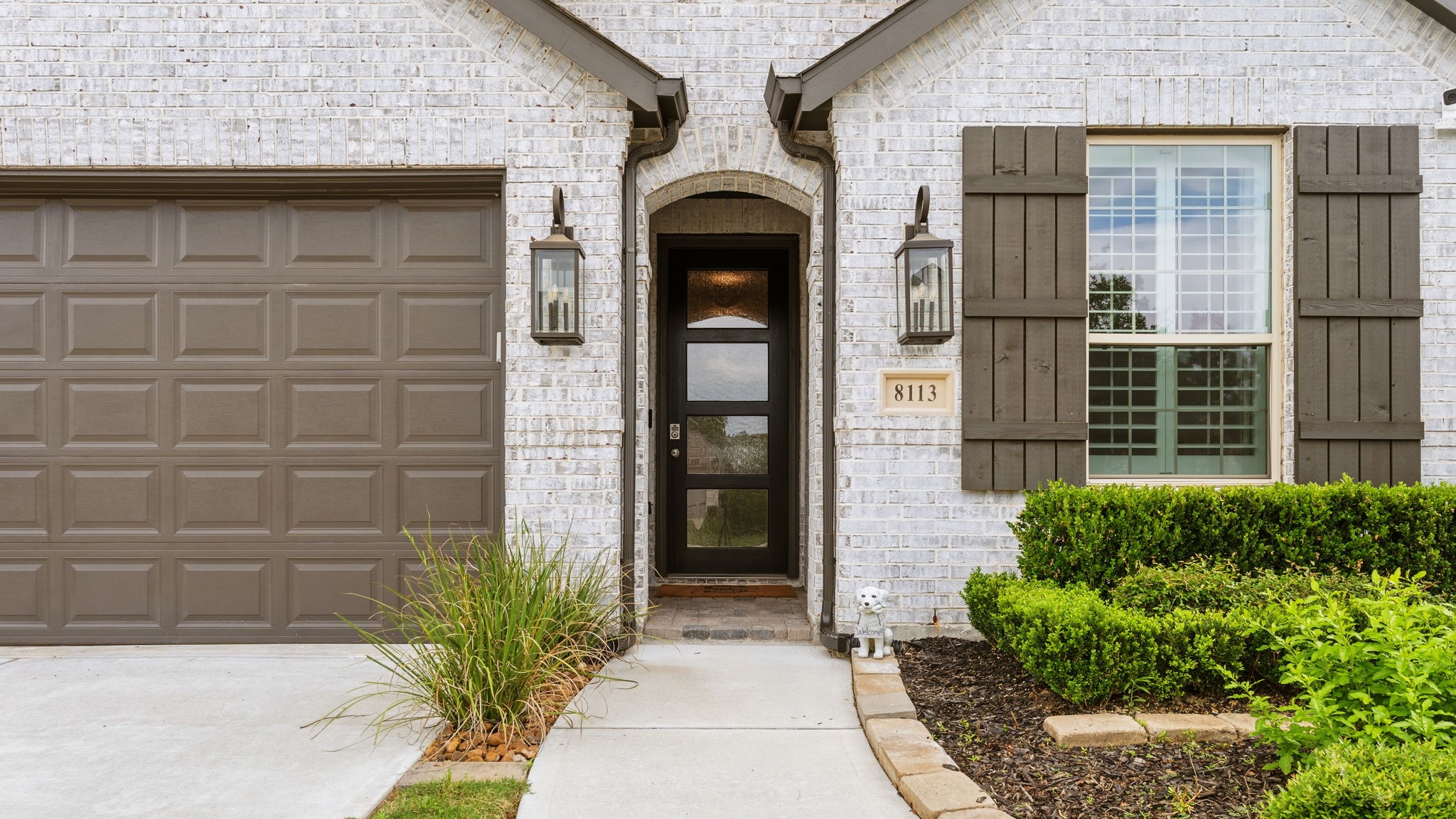 8113 Triumph Bend Way Magnolia, TX 77354 - Photo 4 of 33 a front view of a house with a glass door