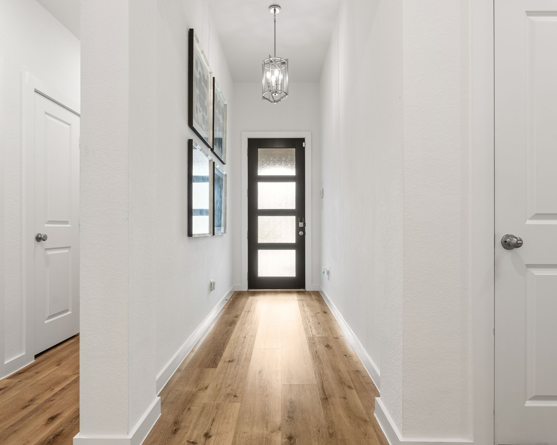8113 Triumph Bend Way Magnolia, TX 77354 - Photo 5 of 33 a view of a hallway with wooden floor and a window