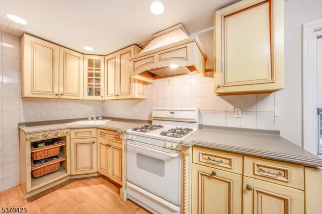 a kitchen with stainless steel appliances granite countertop a stove and a sink