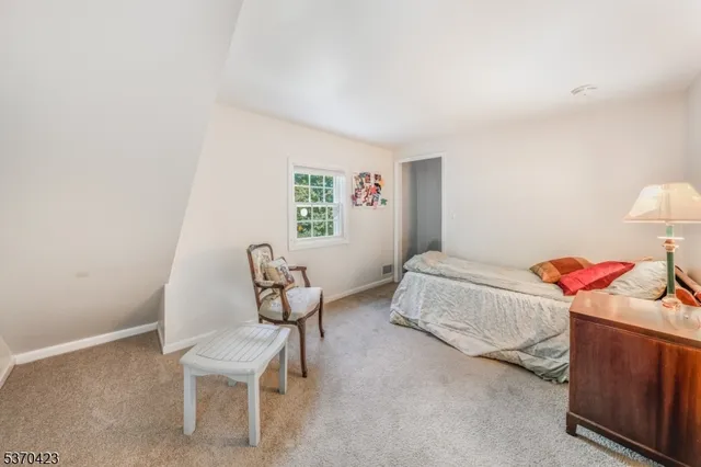 a bedroom with furniture and a chair