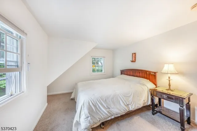 a bedroom with a bed and a night stand