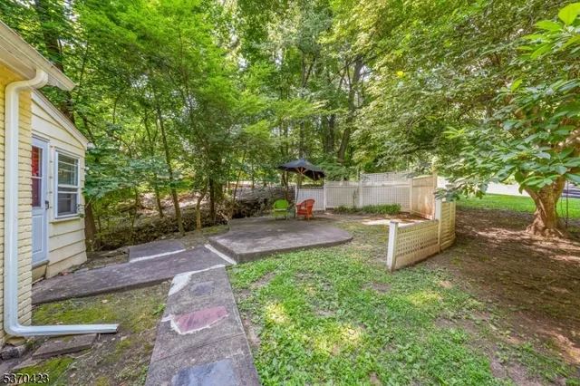 a view of a backyard with a garden and trees
