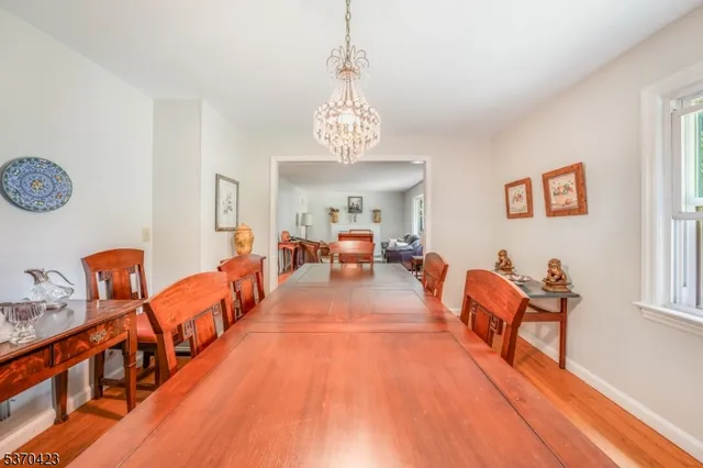 a living room with dining room and wooden floor