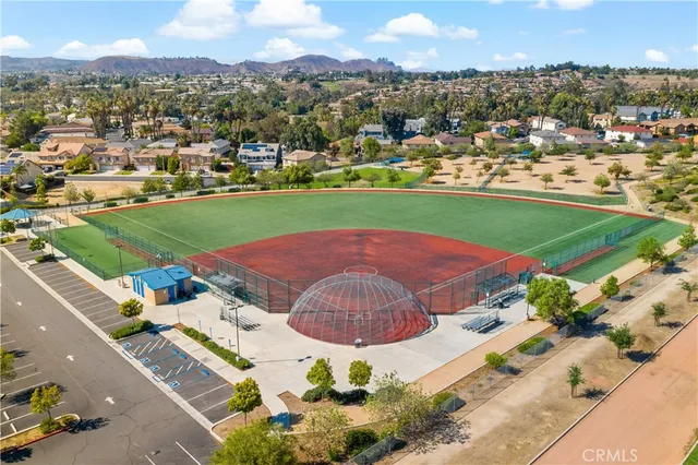 an aerial view of a residential houses with outdoor space and street view