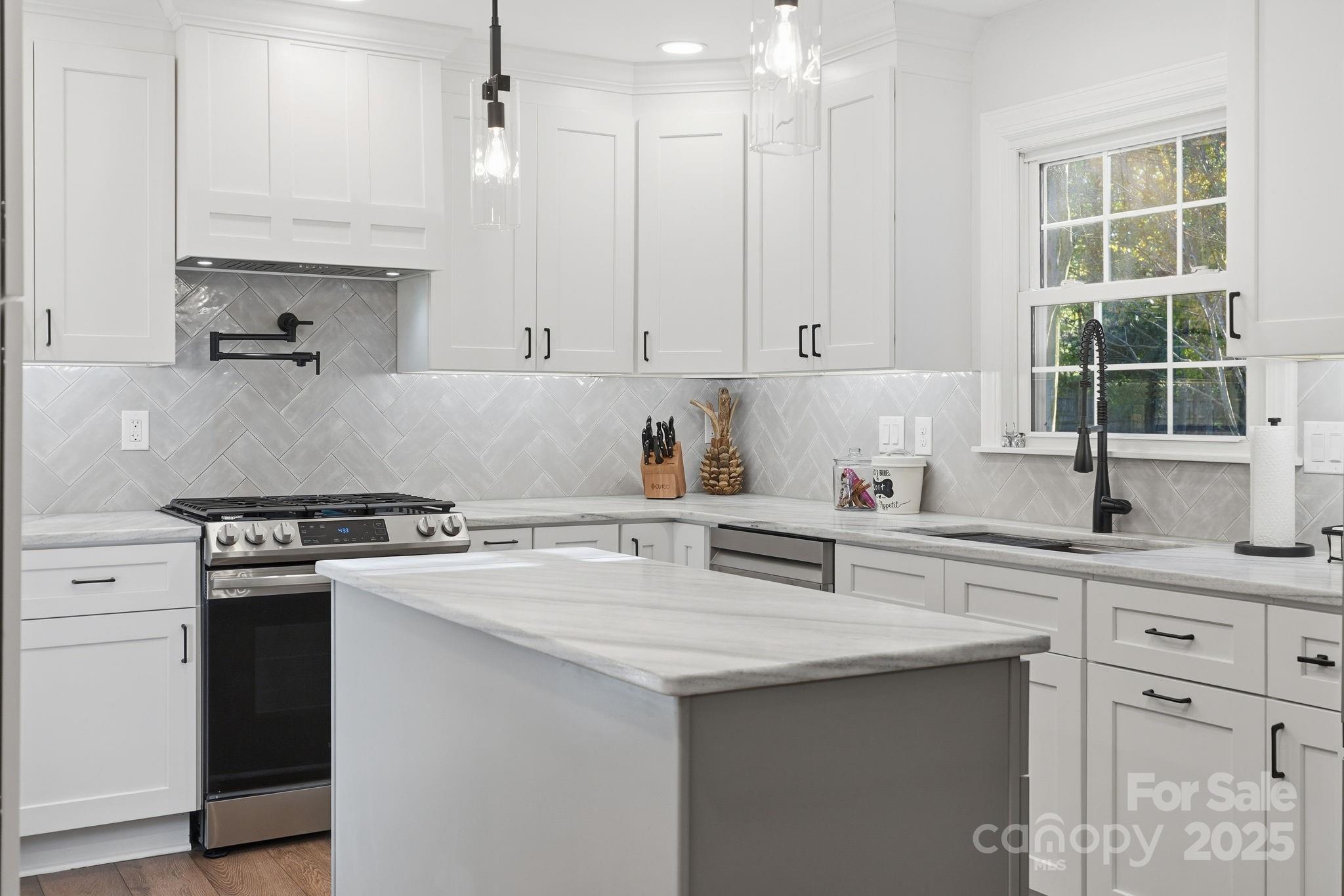 6600 Shaftesbury Road Charlotte, NC 28270 - Photo 15 of 42 a kitchen with cabinets appliances a sink and a window