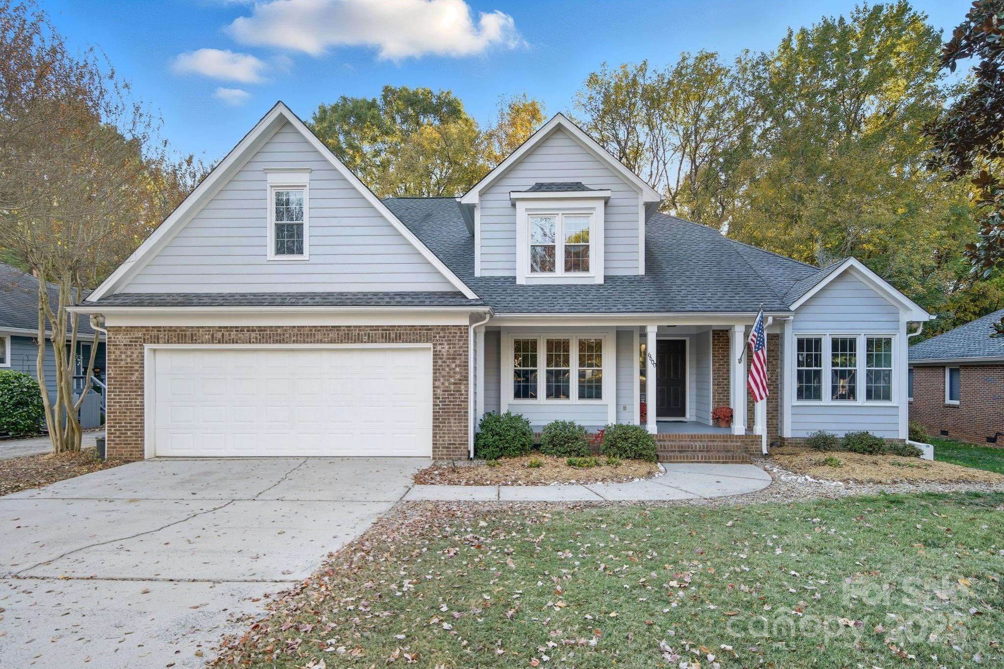 6600 Shaftesbury Road Charlotte, NC 28270 - Photo 2 of 42 a front view of a house with a yard and garage