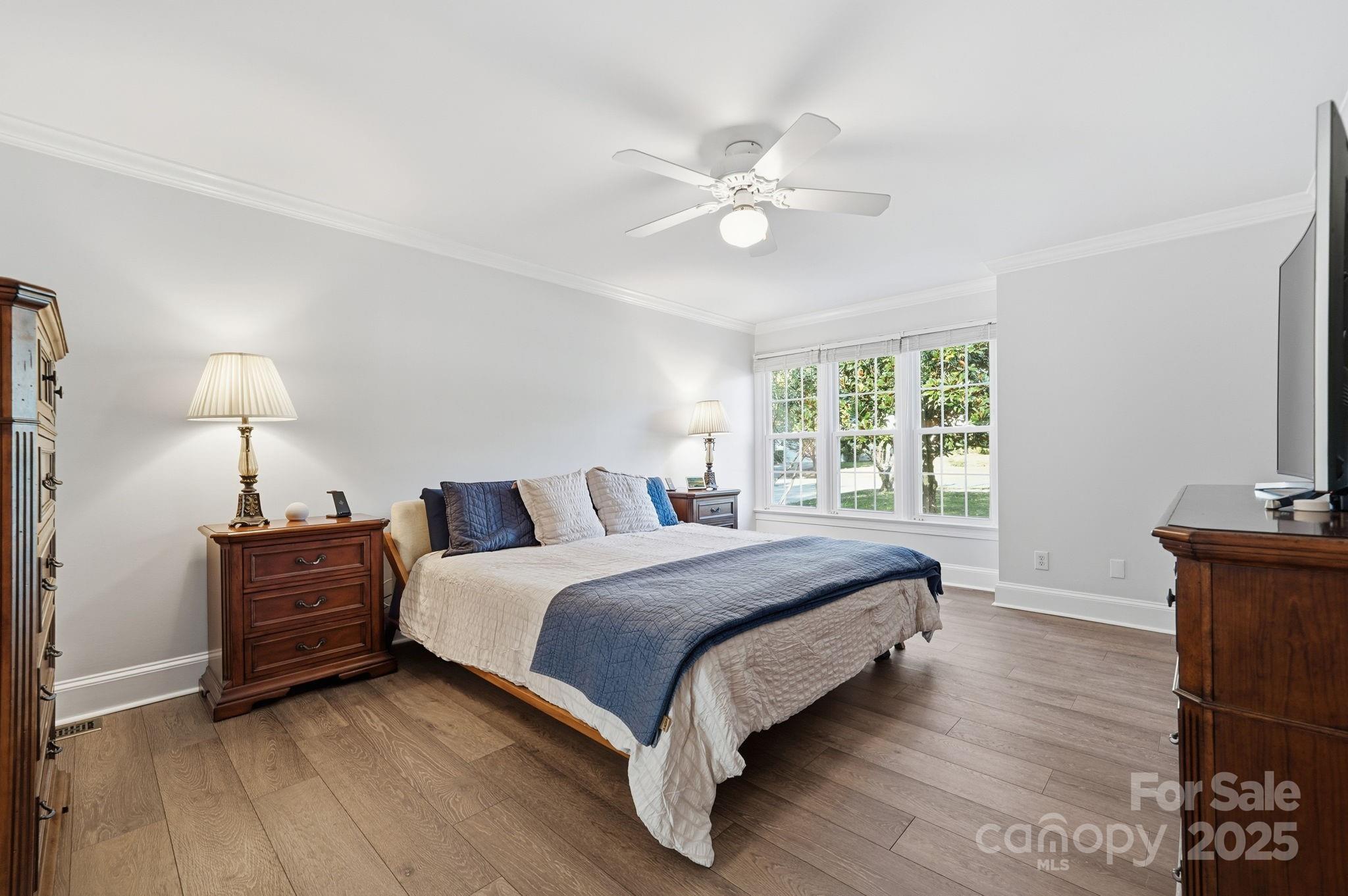 6600 Shaftesbury Road Charlotte, NC 28270 - Photo 22 of 42 a bed room with a bed and a chandelier