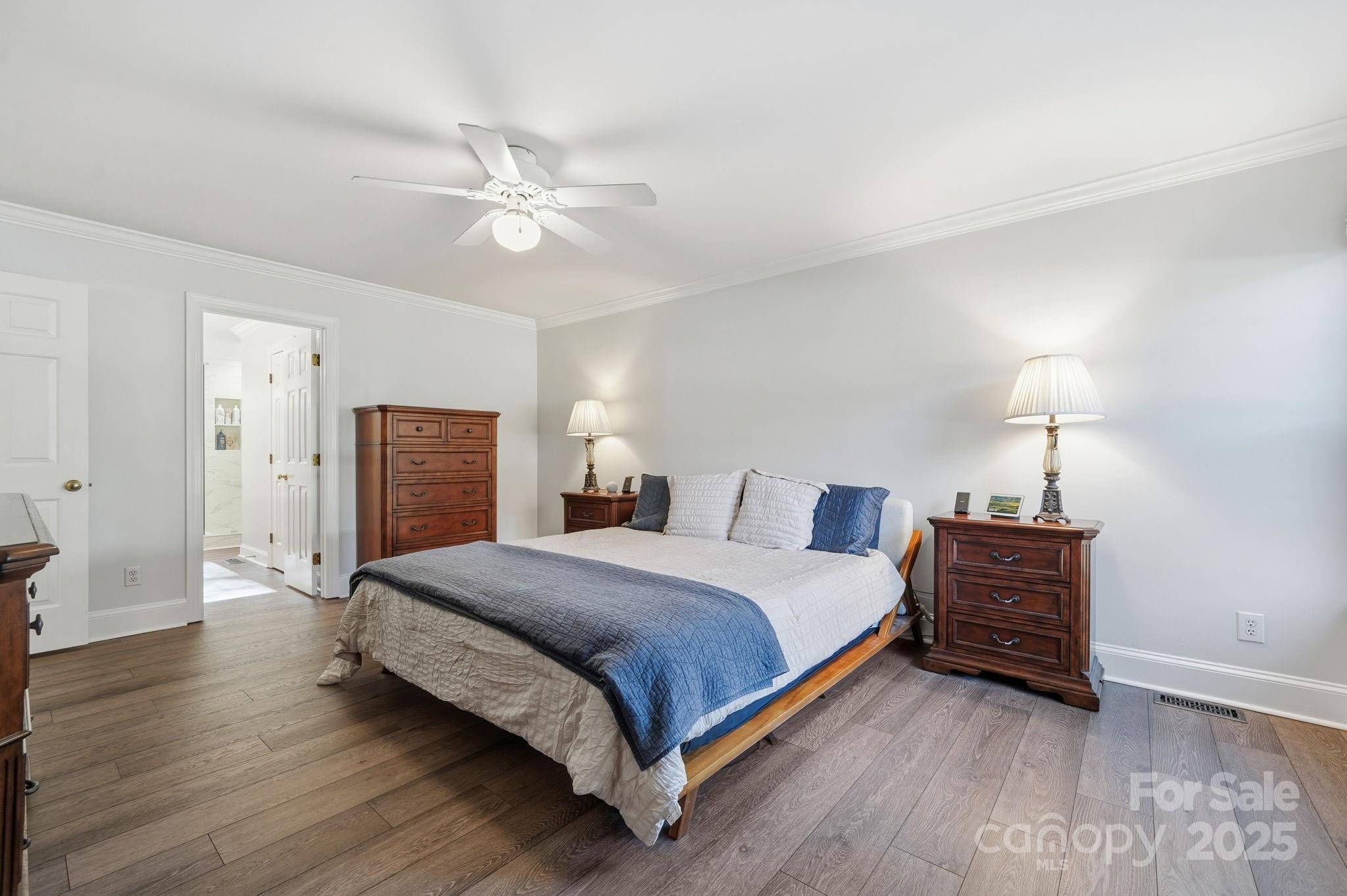 6600 Shaftesbury Road Charlotte, NC 28270 - Photo 23 of 42 a bedroom with a bed and wooden floor