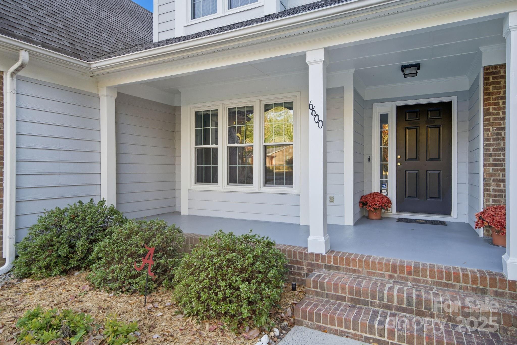 6600 Shaftesbury Road Charlotte, NC 28270 - Photo 3 of 42 a view of a house with a small yard and a large window with wooden floor