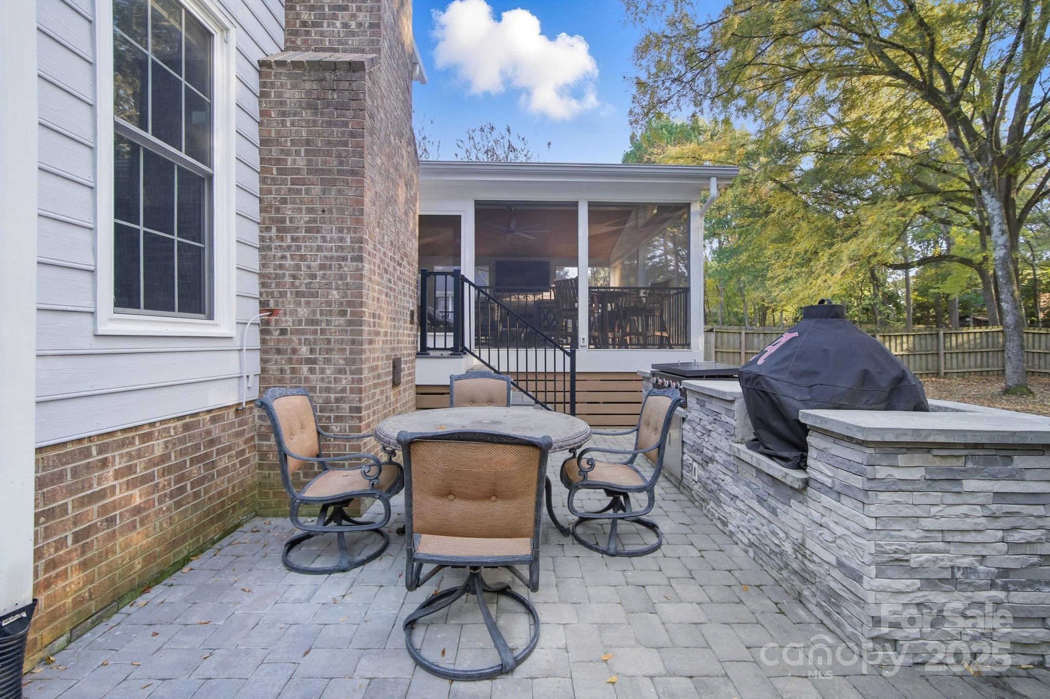 6600 Shaftesbury Road Charlotte, NC 28270 - Photo 37 of 42 a view of a patio with couple of chairs and a fountain