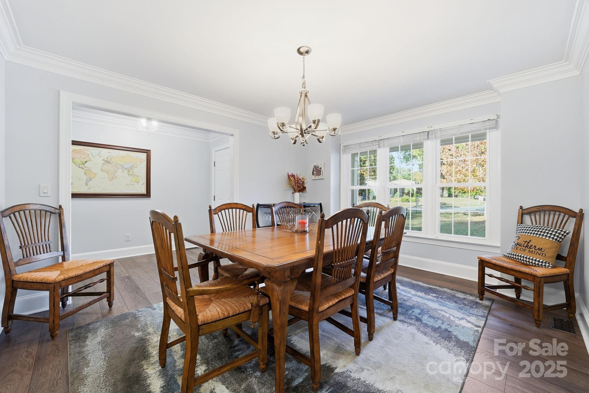 6600 Shaftesbury Road Charlotte, NC 28270 - Photo 7 of 42 a dining room with furniture a rug and a chandelier