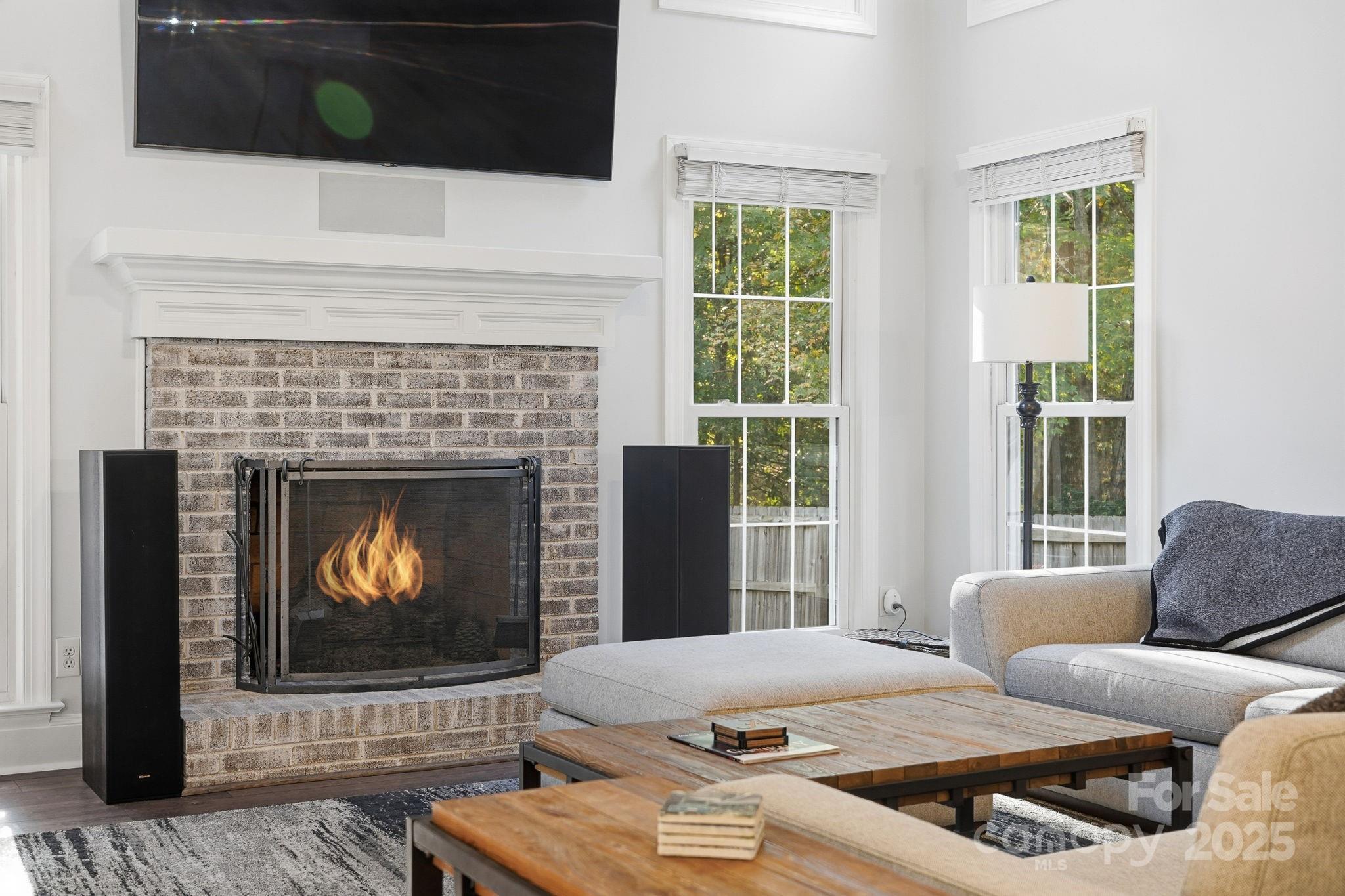 6600 Shaftesbury Road Charlotte, NC 28270 - Photo 9 of 42 a living room with furniture a flat screen tv and a fireplace