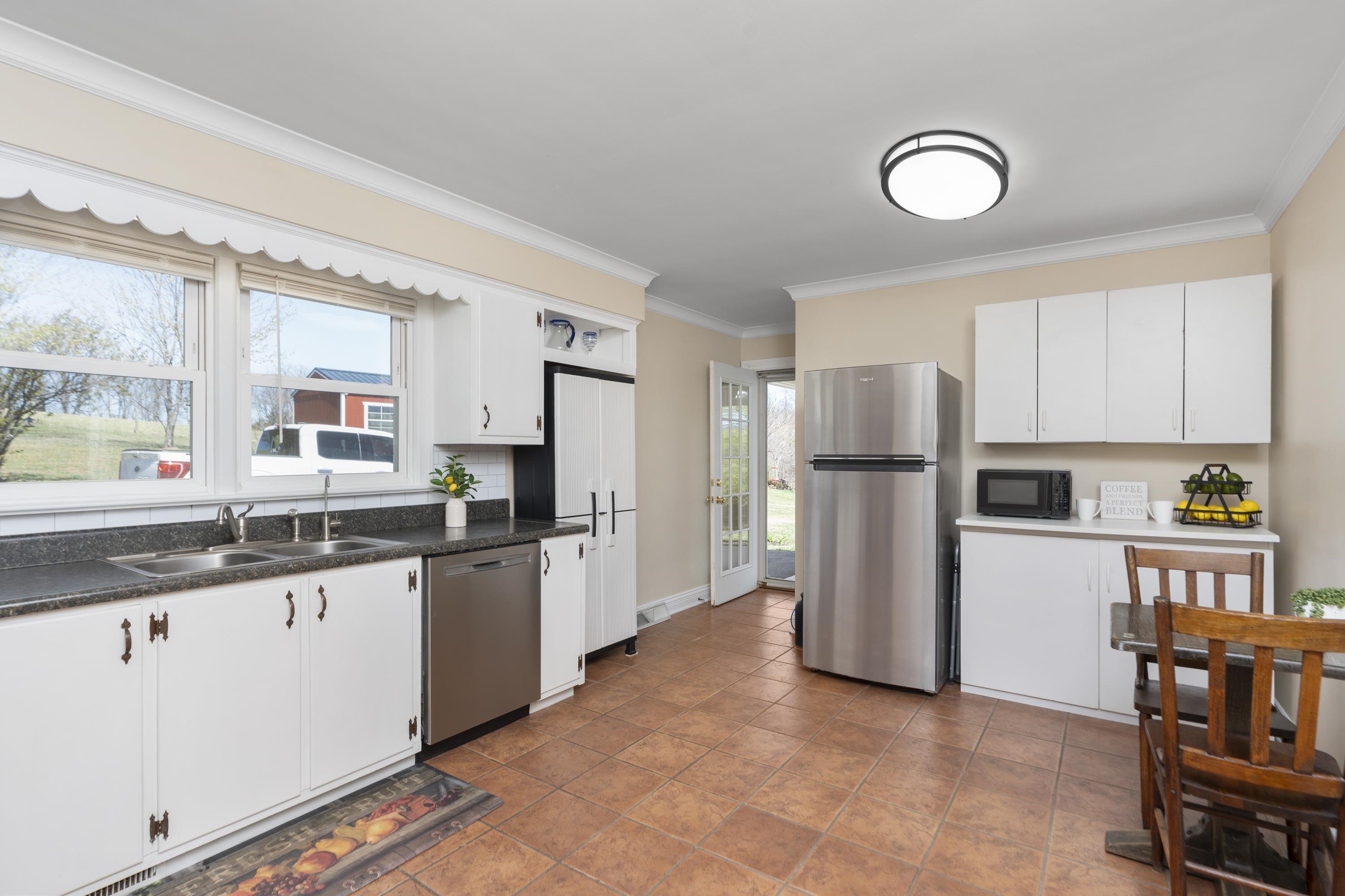 899 Timber Ridge Road Fairfield, VA 24435 - Photo 28 of 65 a kitchen with granite countertop a refrigerator stove top oven and sink