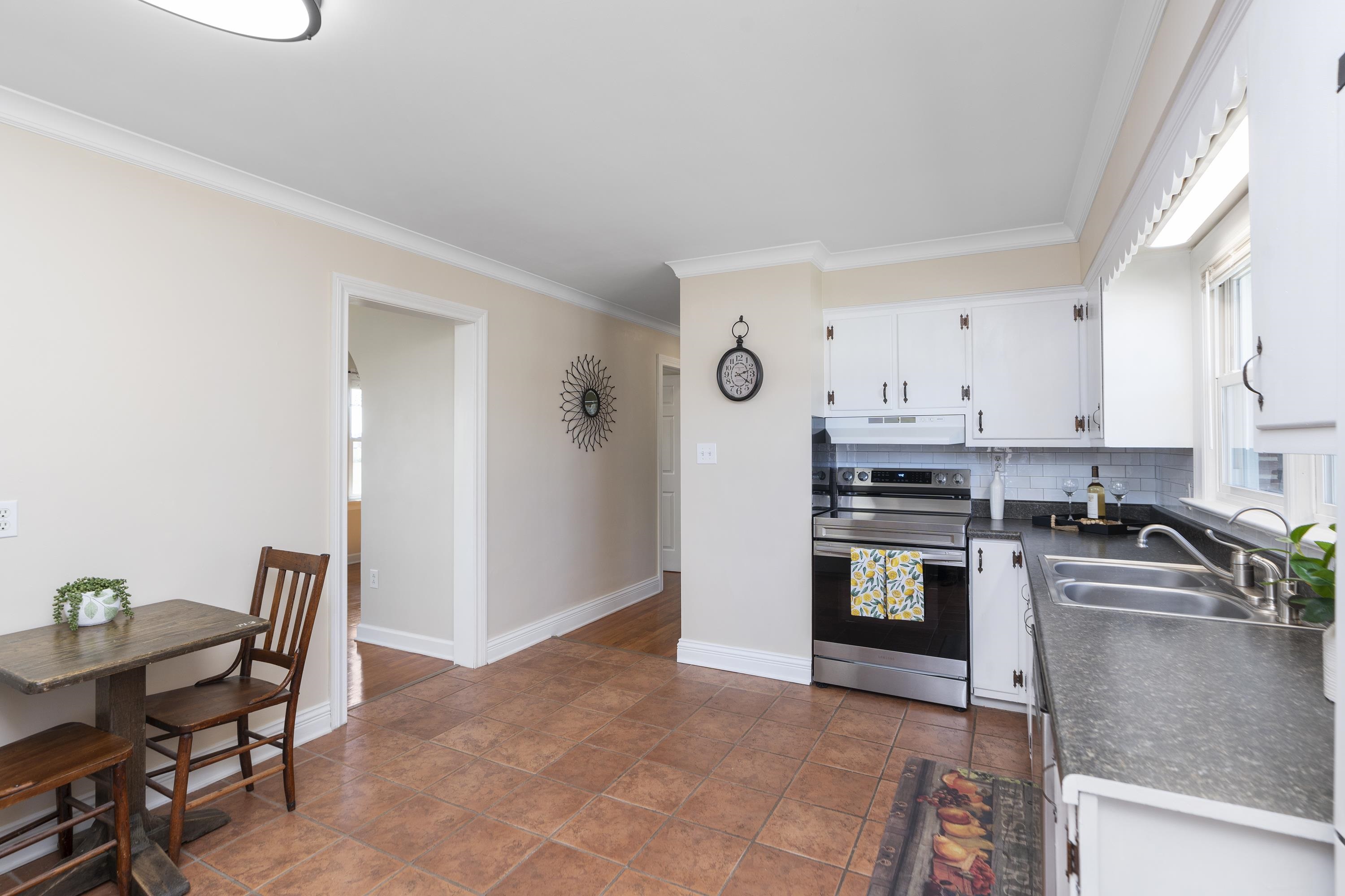 899 Timber Ridge Road Fairfield, VA 24435 - Photo 30 of 65 a kitchen with stainless steel appliances granite countertop a stove top oven a sink a dining table and chairs with wooden floor