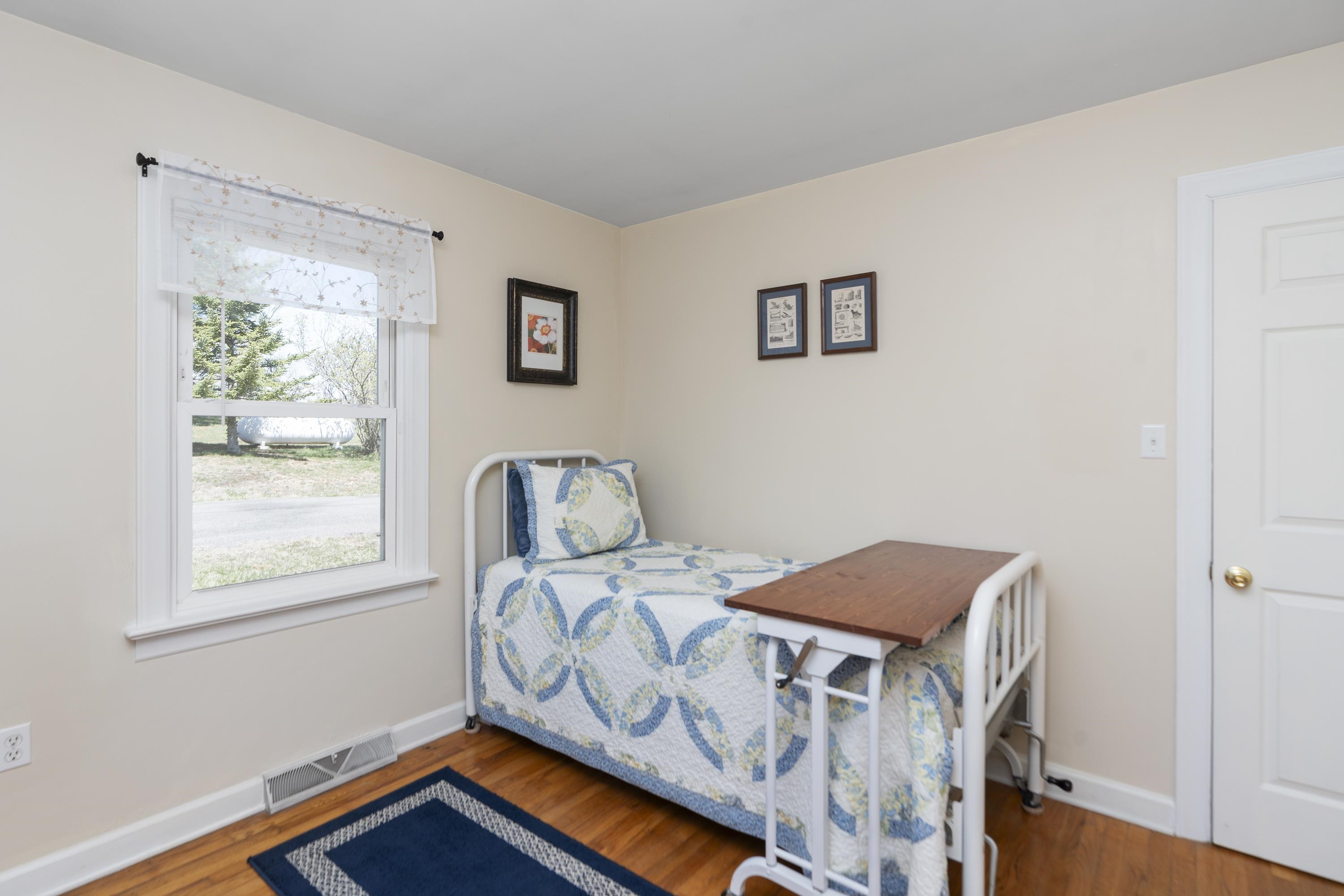 899 Timber Ridge Road Fairfield, VA 24435 - Photo 47 of 65 a bedroom with a bed and wooden floor