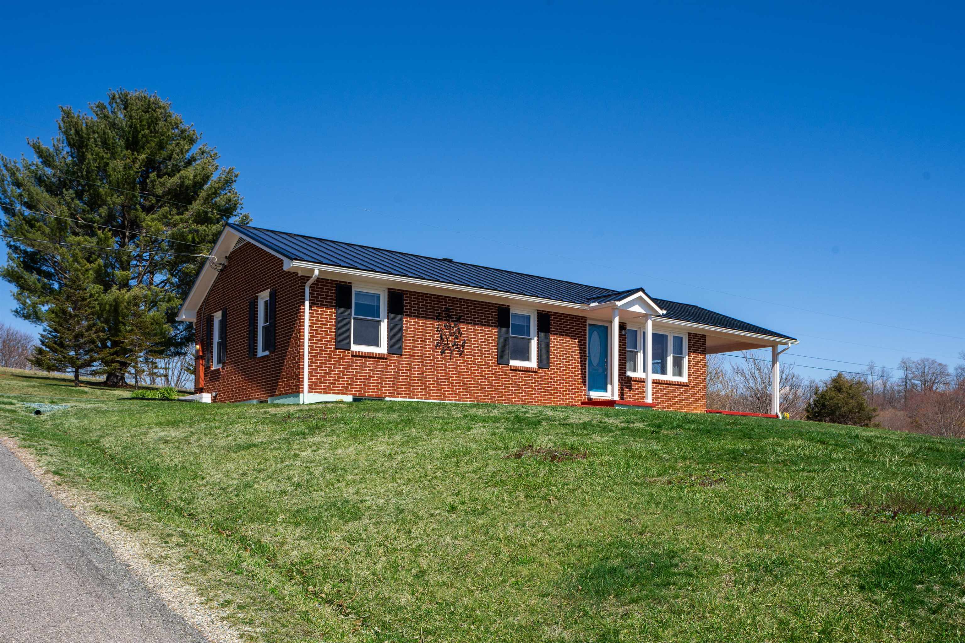 899 Timber Ridge Road Fairfield, VA 24435 - Photo 6 of 65 a house that is sitting in the grass with large trees