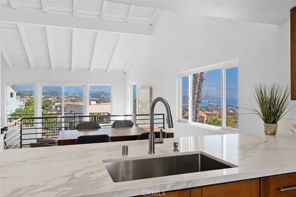 a kitchen with a sink and a large window