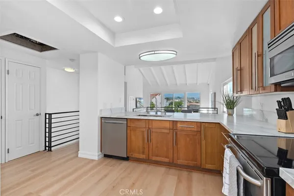 a kitchen with stainless steel appliances granite countertop a sink and cabinets