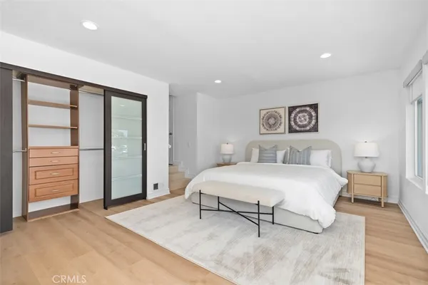 a bedroom with a large bed and a window