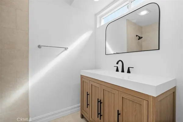 a bathroom with a sink vanity and a mirror