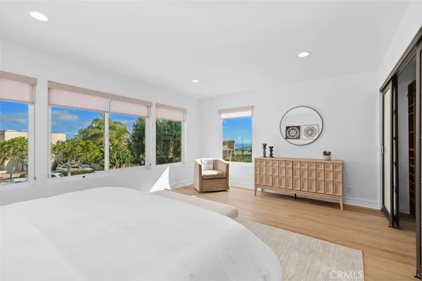 a bedroom with furniture and a large window