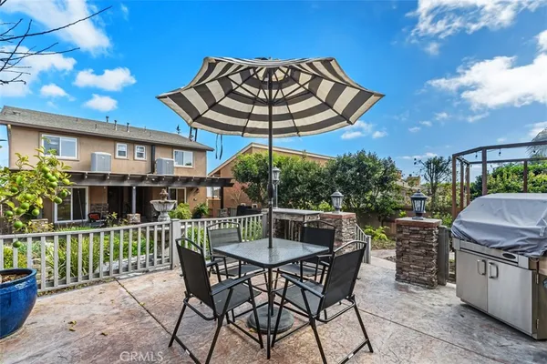 a patio with a yard table and chairs