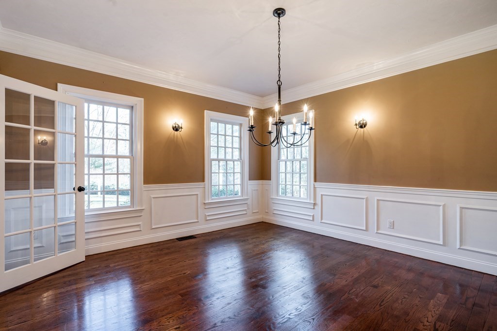50 Corn Road Bolton, MA 01740 - Photo 11 of 40 a view of an empty room with wooden floor and windows
