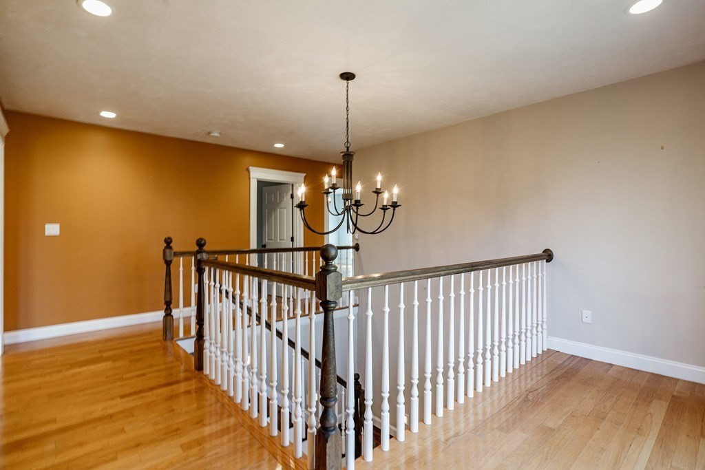 50 Corn Road Bolton, MA 01740 - Photo 18 of 40 a view of a hallway with a chandelier