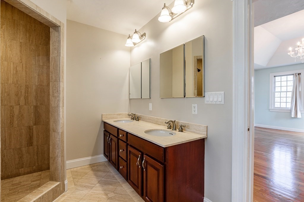 50 Corn Road Bolton, MA 01740 - Photo 23 of 40 a bathroom with a double vanity sink and a mirror