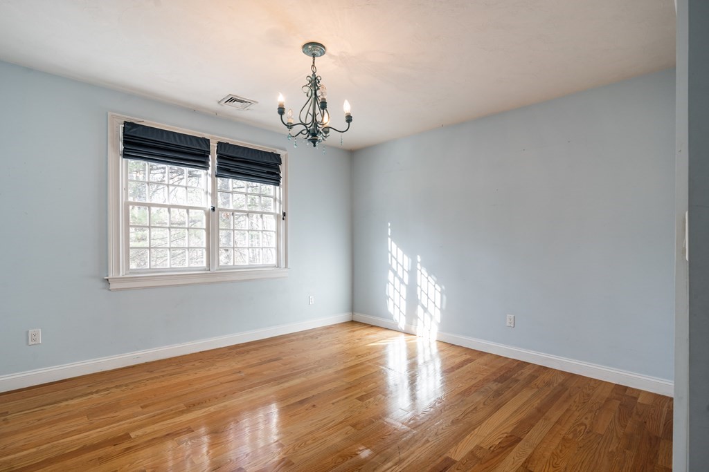 50 Corn Road Bolton, MA 01740 - Photo 25 of 40 a view of an empty room with wooden floor and a window