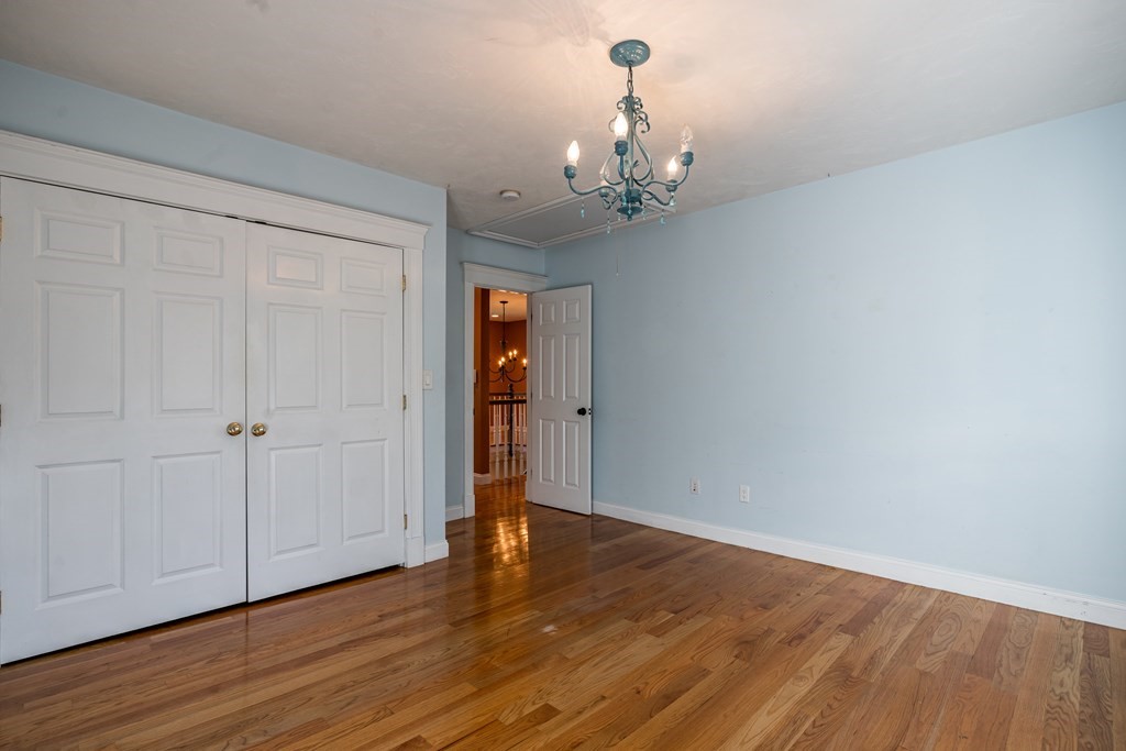50 Corn Road Bolton, MA 01740 - Photo 26 of 40 a view of a room with wooden floor and ceiling fan
