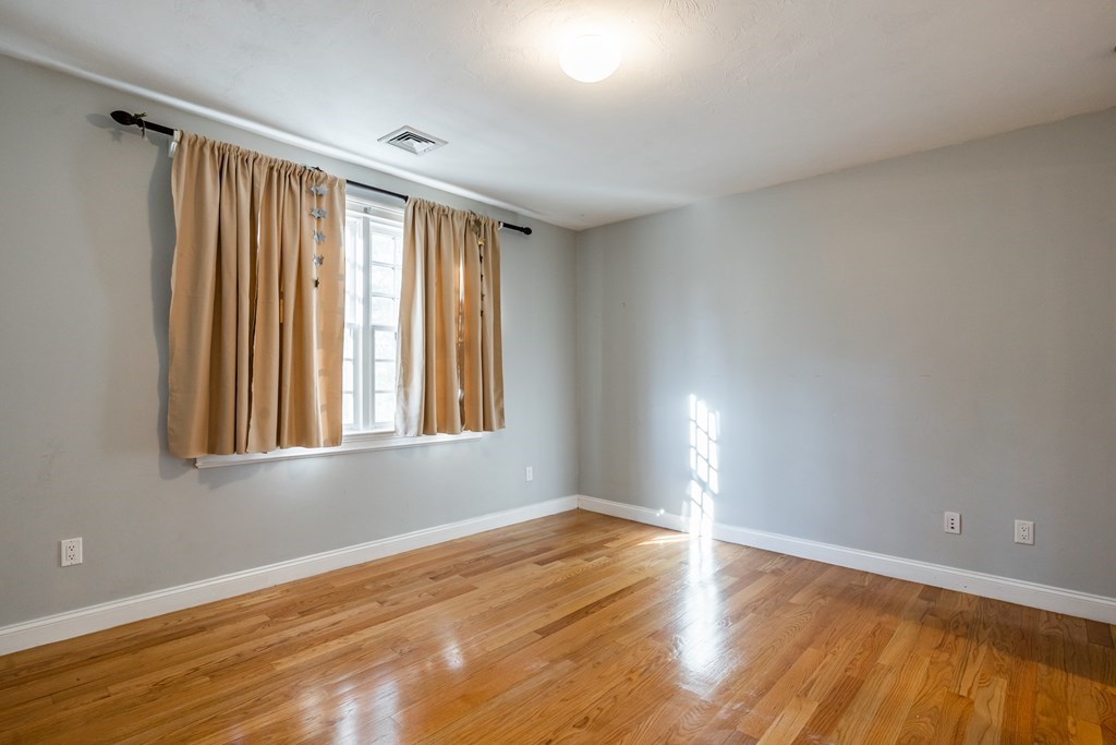 50 Corn Road Bolton, MA 01740 - Photo 28 of 40 a view of an empty room with wooden floor and a window