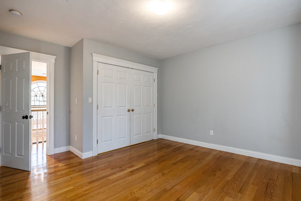 50 Corn Road Bolton, MA 01740 - Photo 29 of 40 a view of empty room with wooden floor and entryway