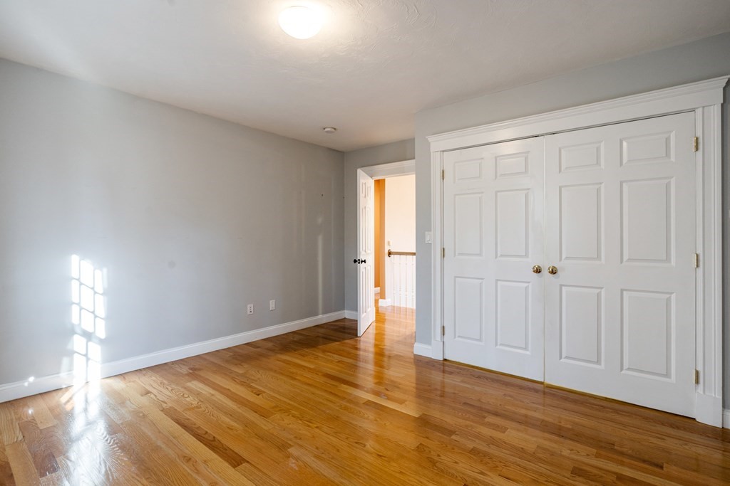 50 Corn Road Bolton, MA 01740 - Photo 30 of 40 a view of an empty room and wooden floor