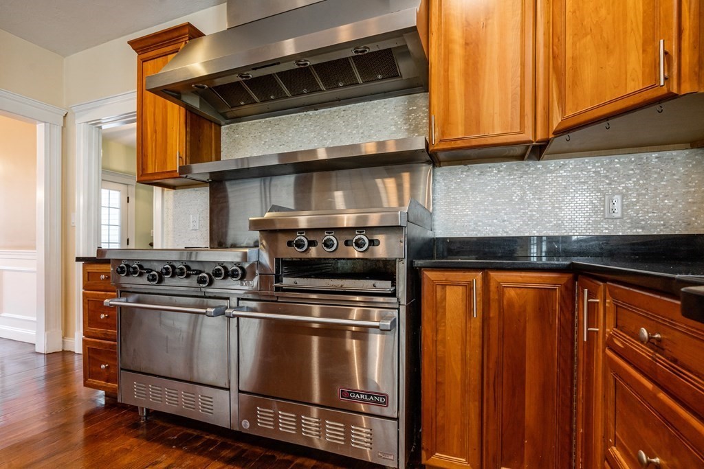 50 Corn Road Bolton, MA 01740 - Photo 3 of 40 a kitchen with stainless steel appliances granite countertop a stove and a microwave